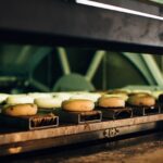 Multiple bagels baking in an industrial oven, showcasing a warm bakery ambiance. - Photo by Rachel Claire on Pexels