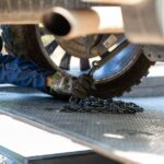 Mechanic securing a vehicle on a service platform with a chain for safe towing. - Photo by Jonathan Reynaga on Pexels